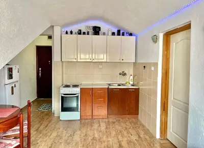 a kitchen with white cabinets and a purple light at Homestay LGBT friendly - DOUBLE BED ROOM in Budva