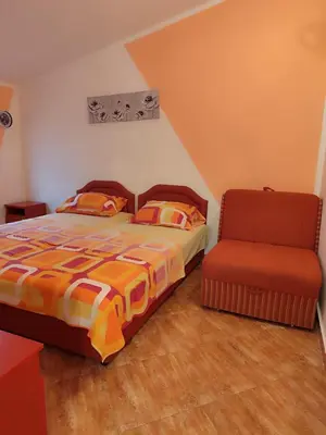 a bedroom with a bed and a chair at Pravo mjesto za odmor in Bar