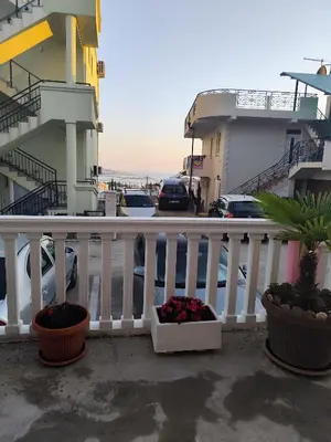 a balcony with two potted plants and a building at Pravo mjesto za odmor in Bar