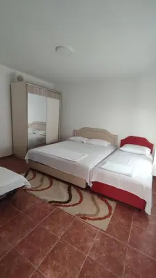 a bedroom with two beds and a tiled floor at Pravo mjesto za odmor in Bar