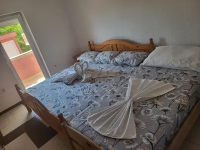 a bed with two umbrellas on top of it at Apartment Asko in Ulcinj