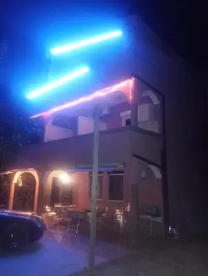 a street sign in front of a building at night at Apartment Asko in Ulcinj