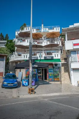 a building with a car parked in front of it at Lana Apartments Nr 11 in Ulcinj