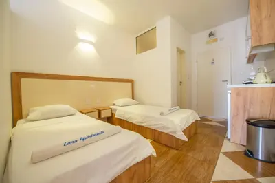 a room with two beds and a kitchen at Lana Apartments Nr 11 in Ulcinj