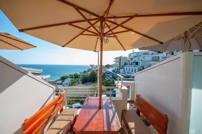 a balcony with a table and an umbrella at Lana Apartments Nr 11 in Ulcinj