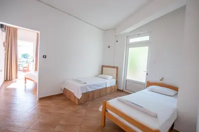 a room with two beds and a window at Lana Apartments Nr 1 in Ulcinj