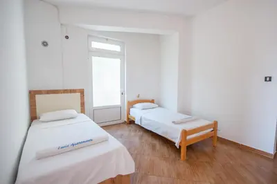 two beds in a room with a window at Lana Apartments Nr 1 in Ulcinj
