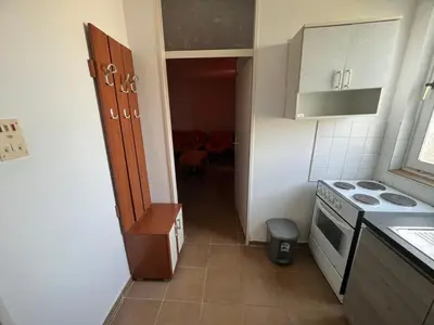 a small kitchen with a sink and a stove at Garsonjera Ulcinj in Ulcinj