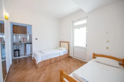 a small room with two beds and a kitchen at Lana Apartments Nr 3 in Ulcinj