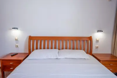 a bedroom with a bed with two nightstands and sidx sidx sidx at Lana Apartments Nr 3 in Ulcinj