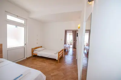 a bedroom with a bed and a room with a mirror at Lana Apartments Nr 3 in Ulcinj