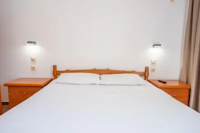 a bedroom with a large white bed with two night stands at Lana Apartments Nr 2 in Ulcinj