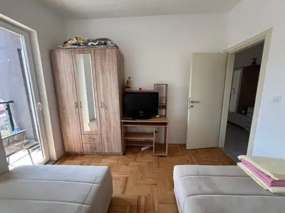 a living room with a couch and a television at Apartment Aleksa in Bar
