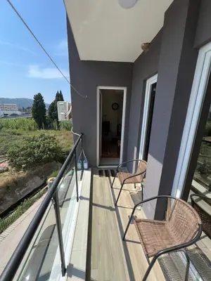 a balcony of a house with chairs and a view at Apartment Aleksa in Bar