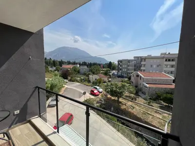 a balcony with a view of a city and a mountain at Apartment Aleksa in Bar