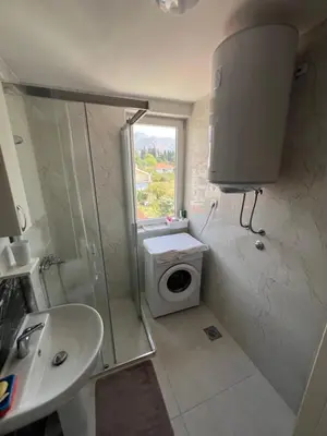 a bathroom with a shower and a toilet and a sink at Apartment Aleksa in Bar