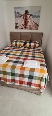a bedroom with a bed with a picture on the wall at Apartman Vesna in Kotor
