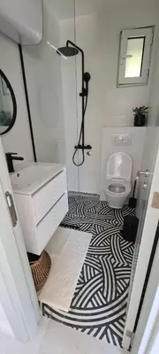 a bathroom with a black and white patterned floor at Apartman Vesna in Kotor