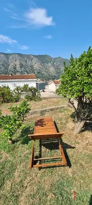 a picnic table sitting in the middle of a field at Apartman Vesna in Kotor
