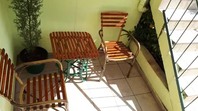 two chairs and a chair sitting on a balcony at Apartments Simo in Petrovac na Moru