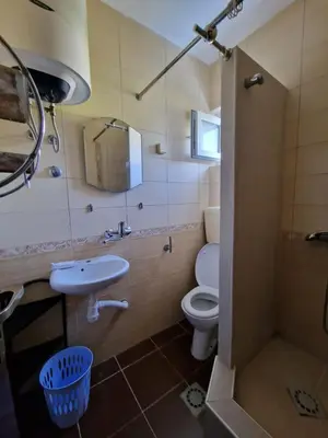 a bathroom with a toilet and a sink and a shower at Villa iTiS in Sutomore