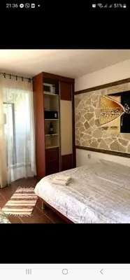 a bedroom with a bed and a stone wall at Villa iTiS in Sutomore