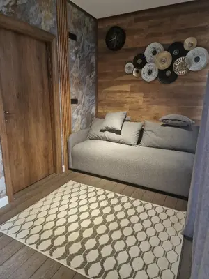 a bedroom with a bed and a wooden wall at Villa iTiS in Sutomore