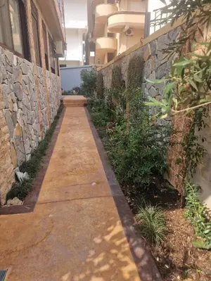 a walkway in a building with a stone wall at Villa iTiS in Sutomore