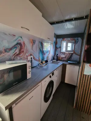 a small kitchen with a sink and a microwave at Villa iTiS in Sutomore
