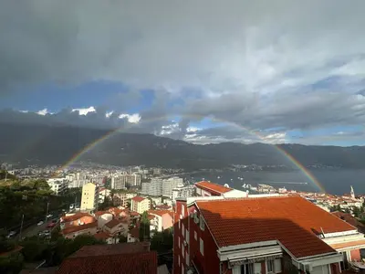 a city with a rainbow in the sky at Sea View Budva in Budva