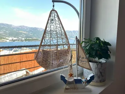 a window sill with a swing and a window at Sea View Budva in Budva