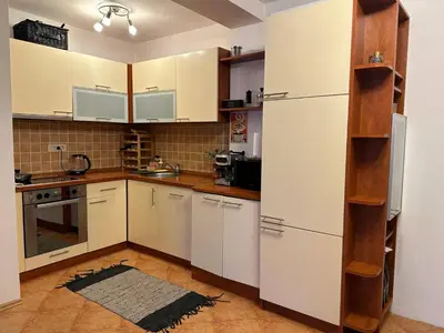 a kitchen with white cabinets and a refrigerator at Sea View Budva in Budva