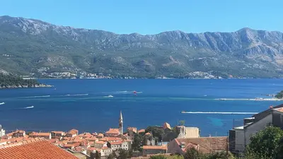 a view of a large body of water with mountains at Sea View Budva in Budva