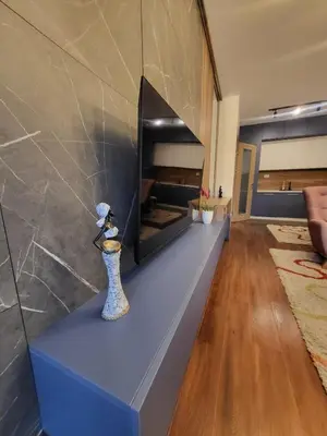 a living room with a fireplace and a vase at Master apartment in Kruševac