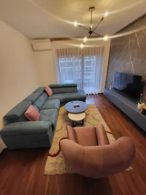 a living room with a couch and a table at Master apartment in Kruševac