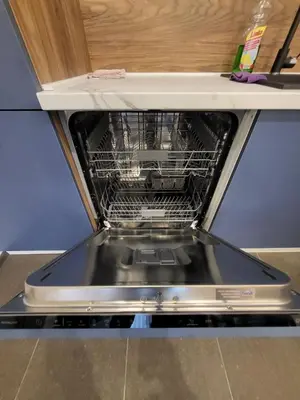a dishwasher with its door open on a counter at Master apartment in Kruševac