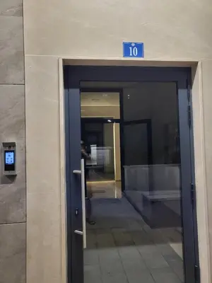 an elevator in a building with a sign on it at Master apartment in Kruševac