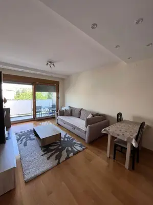 a living room with a couch and a table at Charming and nature surrounded in Podgorica