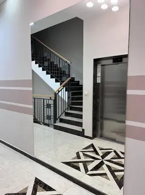 a hallway with stairs and a mirror in a building at Charming and nature surrounded in Podgorica