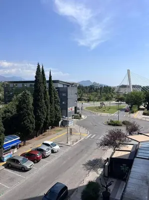 a street with cars parked in a parking lot at Charming and nature surrounded in Podgorica