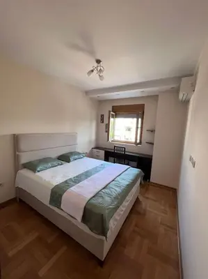 a bedroom with a bed and a window at Charming and nature surrounded in Podgorica