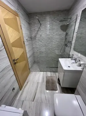 a bathroom with a toilet and a sink and a shower at Charming and nature surrounded in Podgorica