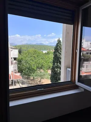 a window in a room with a view of trees at Charming and nature surrounded in Podgorica