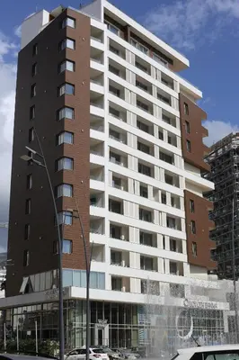 a large building with a parking lot in front of it at AKS Aparments - Wow in Budva