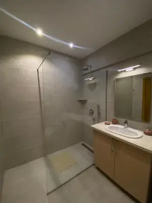 a bathroom with a shower and a sink and a mirror at AKS Aparments - Wow in Budva
