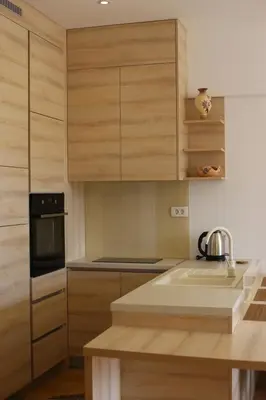 a kitchen with wooden cabinets and a sink at AKS Aparments - Wow in Budva