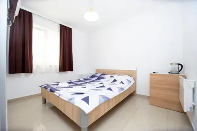 a bedroom with a bed in a room with a window at Apartments Vila Anastasia in Budva