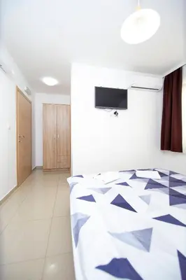 a bedroom with a bed with a geometric pattern at Apartments Vila Anastasia in Budva