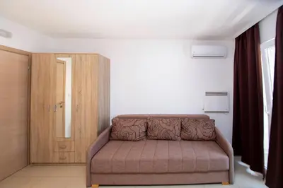 a living room with a couch and a wooden door at Apartments Vila Anastasia in Budva