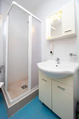 a bathroom with a white sink and a shower at Apartments Vila Anastasia in Budva